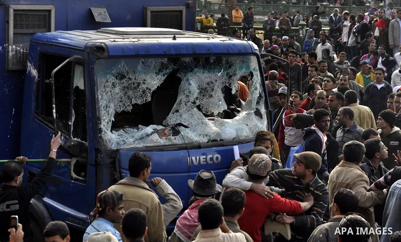 Protesters throw stones at Egyptian riot police during clashes in Tahrir Square in Cairo, Egypt, Saturday, Nov. 19, 2011. Thousands of police clashed with protesters for control of downtown Cairo's Tahrir Square on Satur...