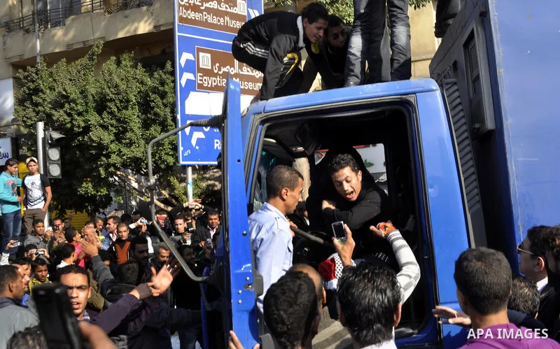 Protesters throw stones at Egyptian riot police during clashes in Tahrir Square in Cairo, Egypt, Saturday, Nov. 19, 2011. Thousands of police clashed with protesters for control of downtown Cairo's Tahrir Square on Satur...