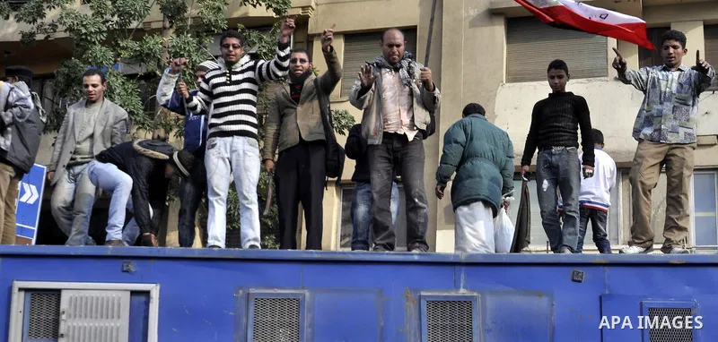 Protesters throw stones at Egyptian riot police during clashes in Tahrir Square in Cairo, Egypt, Saturday, Nov. 19, 2011. Thousands of police clashed with protesters for control of downtown Cairo's Tahrir Square on Satur...