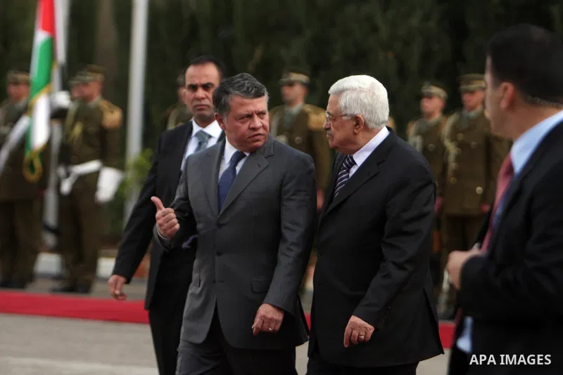 Palestinian President Mahmoud Abbas and King Abdullah of Jordan walk together during a welcoming ceremony in the West Bank city of Ramallah November 21, 2011. Abdullah arrived in Ramallah on Monday for a rare visit to th...