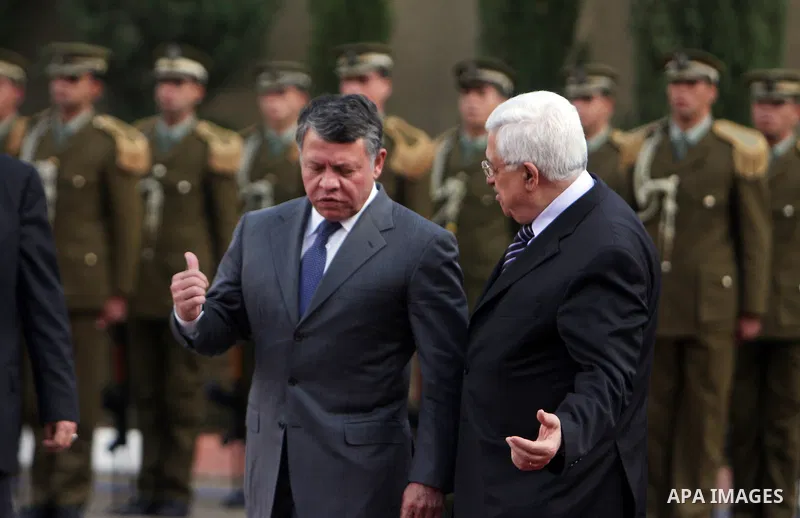 Palestinian President Mahmoud Abbas and King Abdullah of Jordan walk together during a welcoming ceremony in the West Bank city of Ramallah November 21, 2011. Abdullah arrived in Ramallah on Monday for a rare visit to th...