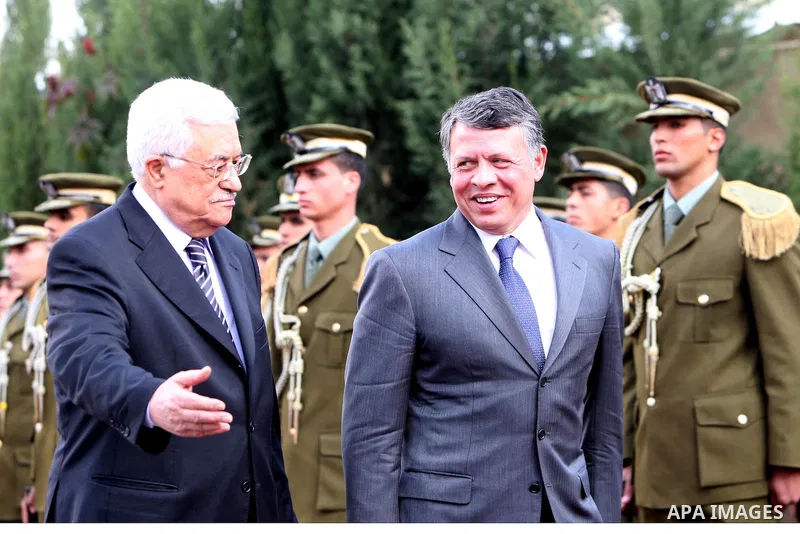 Palestinian President Mahmoud Abbas and King Abdullah of Jordan walk together during a welcoming ceremony in the West Bank city of Ramallah November 21, 2011. Abdullah arrived in Ramallah on Monday for a rare visit to th...
