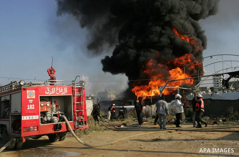 Palestinian firefighters try to extinguish the fire at a smuggle tunnel on the border with Egypt in the southern Gaza Strip town of Rafah on Nov. 21,2011. The cause of the fire is unclear. Photo by Abed Rahim Khatib