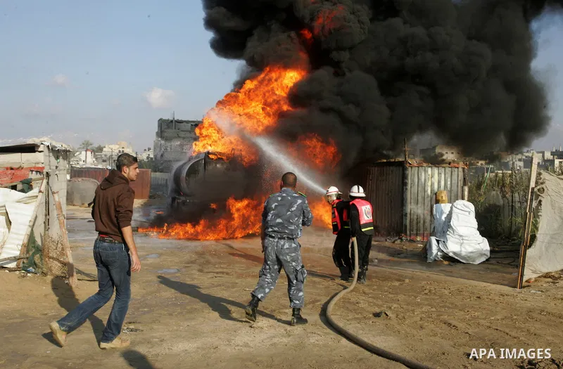 Palestinian firefighters try to extinguish the fire at a smuggle tunnel on the border with Egypt in the southern Gaza Strip town of Rafah on Nov. 21,2011. The cause of the fire is unclear. Photo by Abed Rahim Khatib