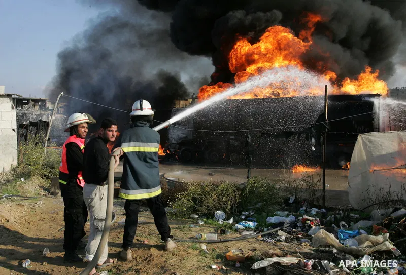 Palestinian firefighters try to extinguish the fire at a smuggle tunnel on the border with Egypt in the southern Gaza Strip town of Rafah on Nov. 21,2011. The cause of the fire is unclear. Photo by Abed Rahim Khatib