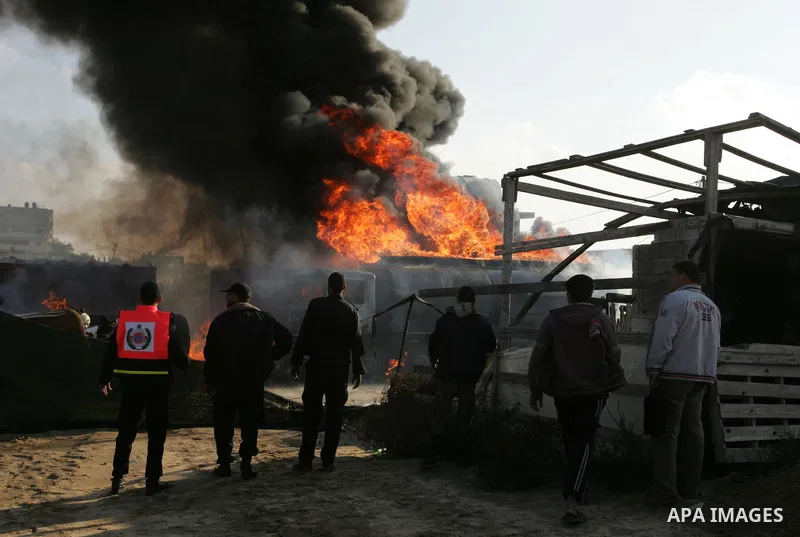 Palestinian firefighters try to extinguish the fire at a smuggle tunnel on the border with Egypt in the southern Gaza Strip town of Rafah on Nov. 21,2011. The cause of the fire is unclear. Photo by Abed Rahim Khatib