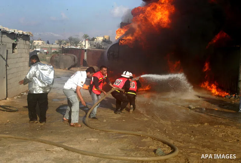 Palestinian firefighters try to extinguish the fire at a smuggle tunnel on the border with Egypt in the southern Gaza Strip town of Rafah on Nov. 21,2011. The cause of the fire is unclear. Photo by Abed Rahim Khatib