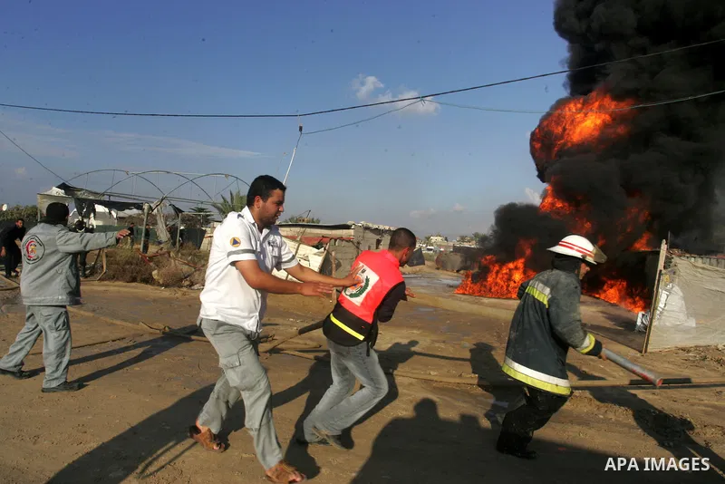 Palestinian firefighters try to extinguish the fire at a smuggle tunnel on the border with Egypt in the southern Gaza Strip town of Rafah on Nov. 21,2011. The cause of the fire is unclear. Photo by Abed Rahim Khatib