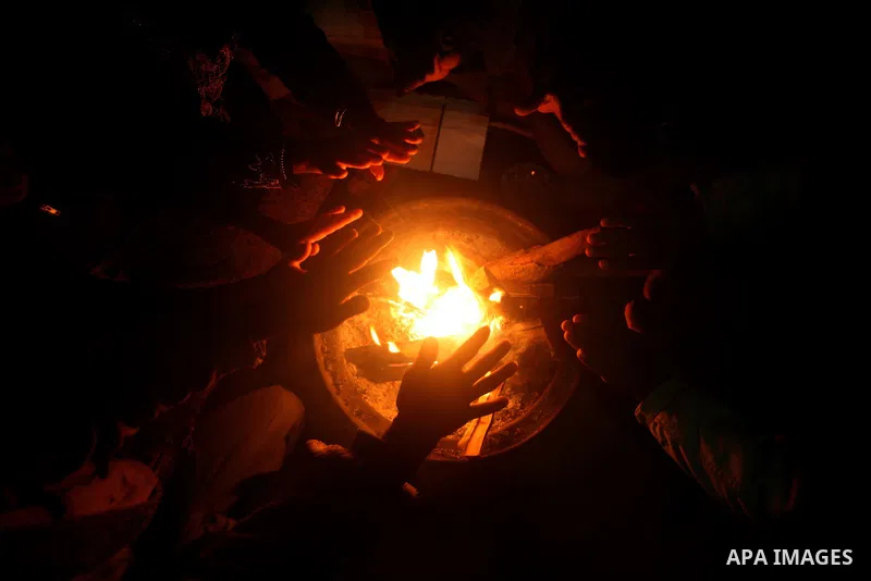 Palestinian bedouins sit inside their tent during heavy rain and cold winds in a camp for poor people in Al-Nussirat refugee camp, central Gaza Strip on 21 November 2011. Photo by Ali Jadallah