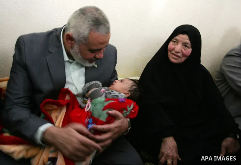 Palestinian Prime Minister in Gaza strip, Ismail Haniyeh sits with the mother of Ahmed al-Sheikh Khalil in the southern Gaza Strip town of Rafah on Nov. 22,2011. Ahmed al-Sheikh Khalil the commander of al-Quds Brigades t...
