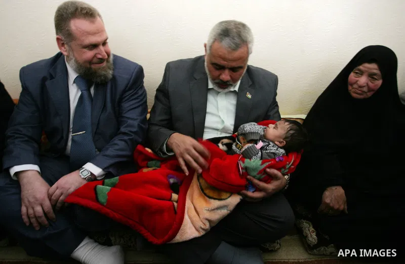 Palestinian Prime Minister in Gaza strip, Ismail Haniyeh sits with the mother of Ahmed al-Sheikh Khalil in the southern Gaza Strip town of Rafah on Nov. 22,2011. Ahmed al-Sheikh Khalil the commander of al-Quds Brigades t...