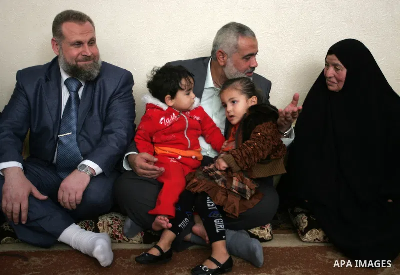 Palestinian Prime Minister in Gaza strip, Ismail Haniyeh sits with the mother of Ahmed al-Sheikh Khalil in the southern Gaza Strip town of Rafah on Nov. 22,2011. Ahmed al-Sheikh Khalil the commander of al-Quds Brigades t...