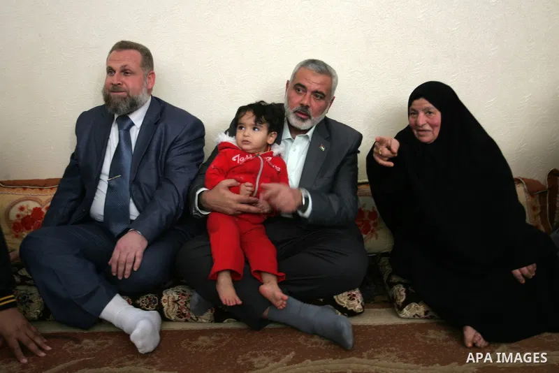 Palestinian Prime Minister in Gaza strip, Ismail Haniyeh sits with the mother of Ahmed al-Sheikh Khalil in the southern Gaza Strip town of Rafah on Nov. 22,2011. Ahmed al-Sheikh Khalil the commander of al-Quds Brigades t...