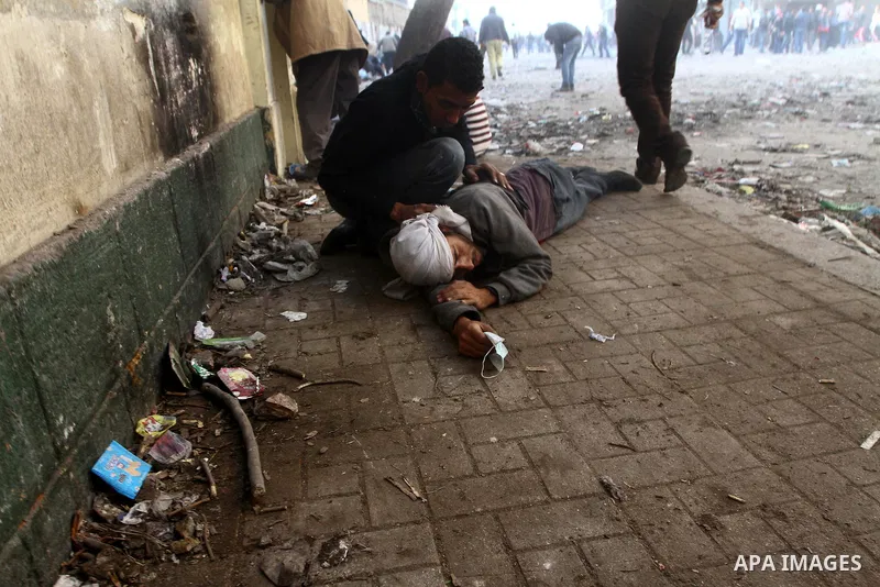 Egyptian protesters clash with riot police in a Cairo street on November 22, 2011. Thousands of protesters swarmed Cairo's Tahrir Square to demand an end to military rule, heightening tension after days of deadly clashes...