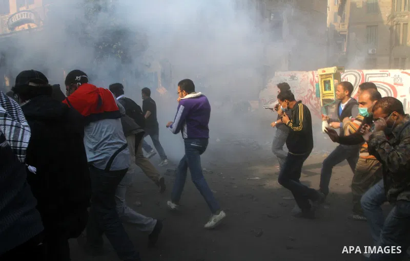 Egyptian protesters clash with riot police in a Cairo street on November 22, 2011. Thousands of protesters swarmed Cairo's Tahrir Square to demand an end to military rule, heightening tension after days of deadly clashes...
