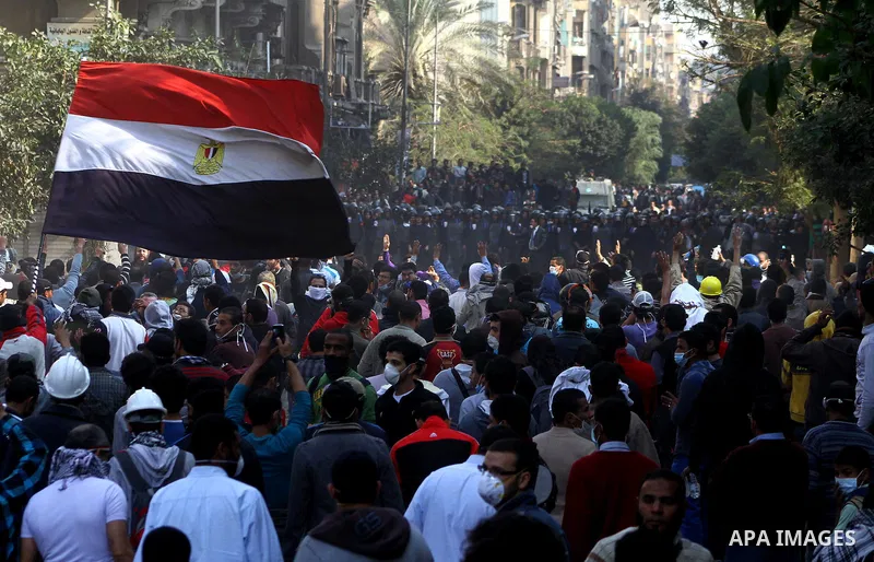 Egyptian protesters clash with riot police in a Cairo street on November 22, 2011. Thousands of protesters swarmed Cairo's Tahrir Square to demand an end to military rule, heightening tension after days of deadly clashes...