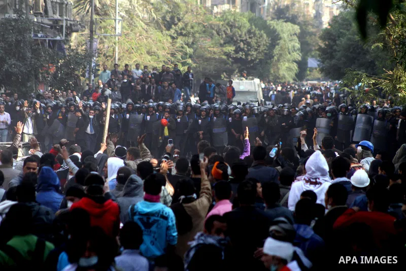 Egyptian protesters clash with riot police in a Cairo street on November 22, 2011. Thousands of protesters swarmed Cairo's Tahrir Square to demand an end to military rule, heightening tension after days of deadly clashes...