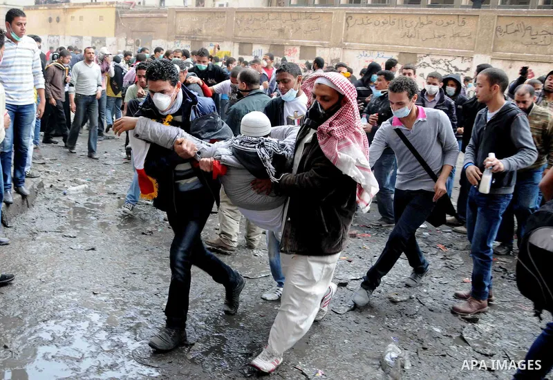 Egyptian protesters clash with riot police in a Cairo street on November 22, 2011. Thousands of protesters swarmed Cairo's Tahrir Square to demand an end to military rule, heightening tension after days of deadly clashes...