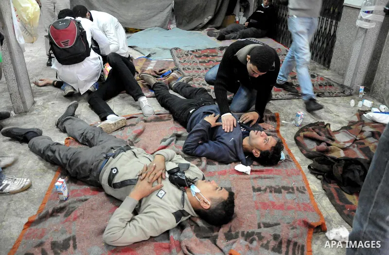 Egyptian protesters clash with riot police in a Cairo street on November 22, 2011. Thousands of protesters swarmed Cairo's Tahrir Square to demand an end to military rule, heightening tension after days of deadly clashes...