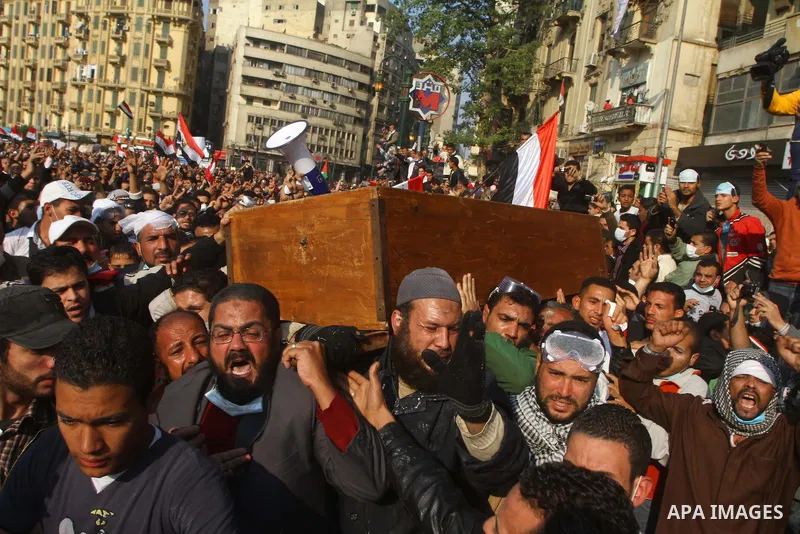 Protesters in Tahrir Square attend a funeral carrying the coffin of a protester who died in clashes with riot police. Egyptians frustrated with military rule battled police in the streets again on Tuesday as the generals...