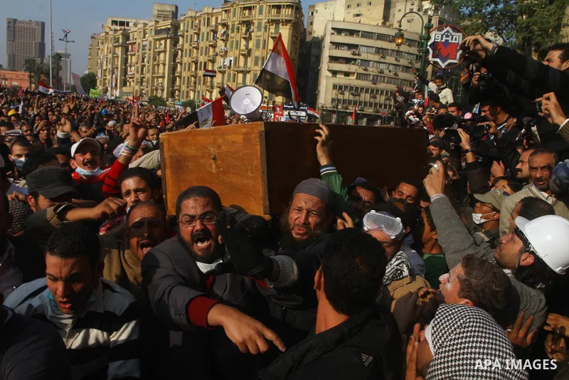 Protesters in Tahrir Square attend a funeral carrying the coffin of a protester who died in clashes with riot police. Egyptians frustrated with military rule battled police in the streets again on Tuesday as the generals...