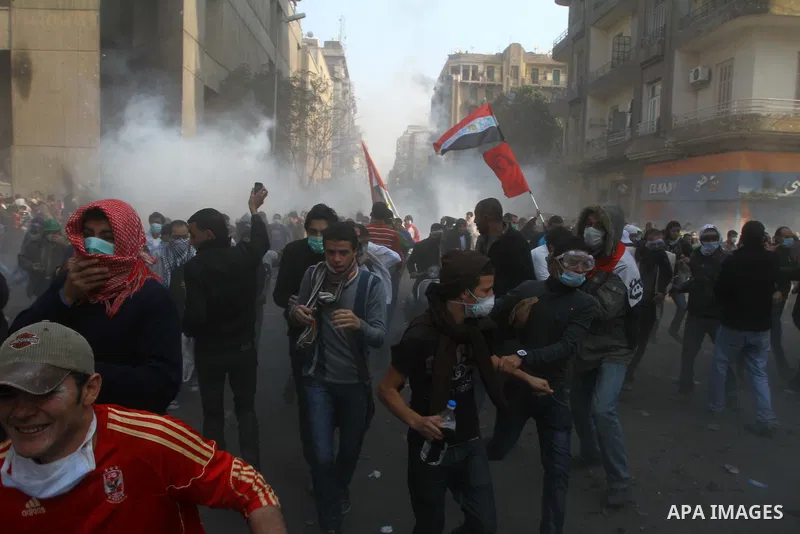 Egyptian protesters clash with riot police in a Cairo street. Thousands of protesters swarmed Cairo's Tahrir Square to demand an end to military rule, heightening tension after days of deadly clashes that threaten to der...