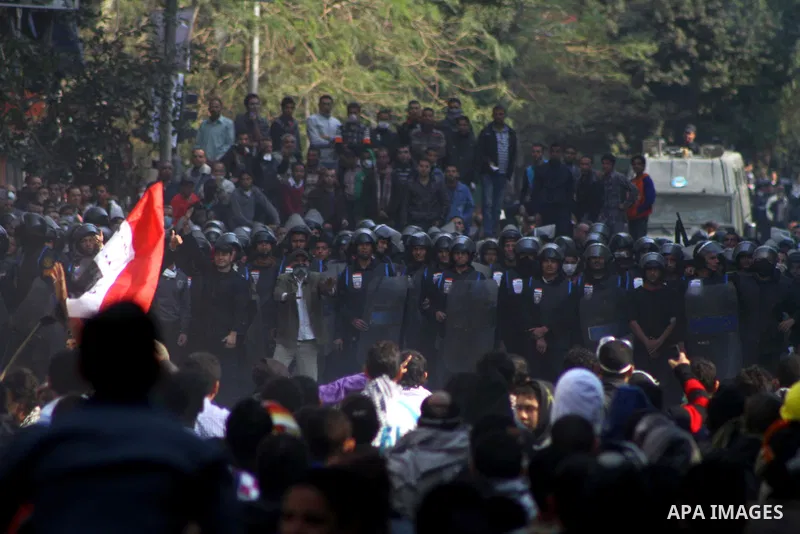 Egyptian protesters clash with riot police in a Cairo street. Thousands of protesters swarmed Cairo's Tahrir Square to demand an end to military rule, heightening tension after days of deadly clashes that threaten to der...