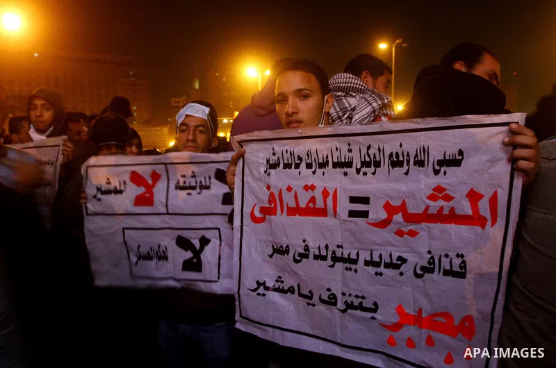 Protesters chant anti-military council slogans at Tahrir Square in Cairo November 22, 2011. Egypt's ruling generals offered on Tuesday to transfer power to a civilian president by July in a dramatic attempt to placate pr...