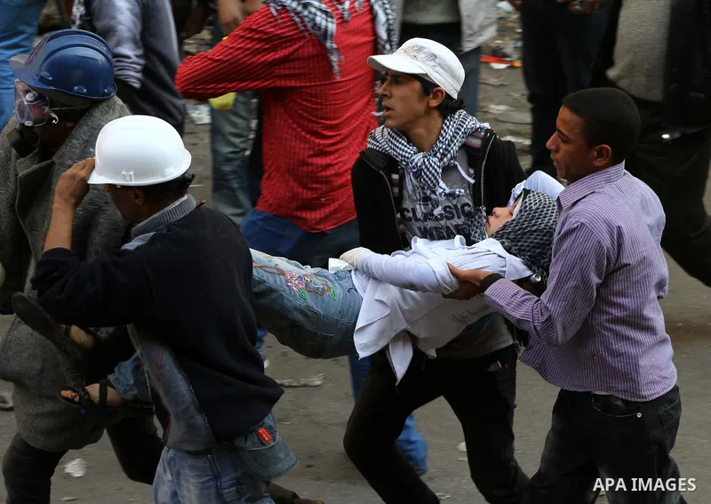 Egyptian protestors clash with riot police, not pictured, near Tahrir square in Cairo, Egypt, Wednesday, Nov. 23, 2011. Egyptian police are clashing with anti-government protesters for a fifth day in Cairo. Tens of thous...
