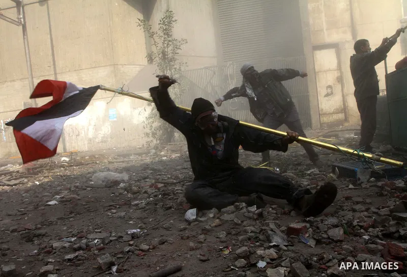 Egyptian protestors clash with riot police, not pictured, near Tahrir square in Cairo, Egypt, Wednesday, Nov. 23, 2011. Egyptian police are clashing with anti-government protesters for a fifth day in Cairo. Tens of thous...