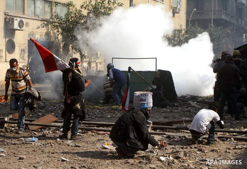 Egyptian protestors clash with riot police, not pictured, near Tahrir square in Cairo, Egypt, Wednesday, Nov. 23, 2011. Egyptian police are clashing with anti-government protesters for a fifth day in Cairo. Tens of thous...