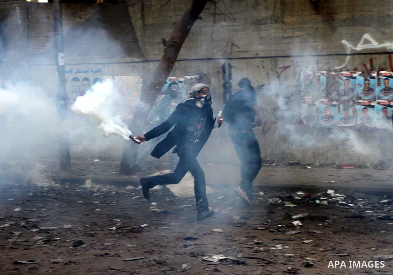 Egyptian protestors clash with riot police, not pictured, near Tahrir square in Cairo, Egypt, Wednesday, Nov. 23, 2011. Egyptian police are clashing with anti-government protesters for a fifth day in Cairo. Tens of thous...