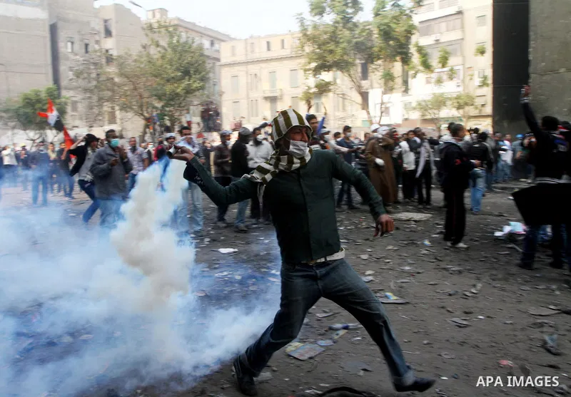 Egyptian protestors clash with riot police, not pictured, near Tahrir square in Cairo, Egypt, Wednesday, Nov. 23, 2011. Egyptian police are clashing with anti-government protesters for a fifth day in Cairo. Tens of thous...