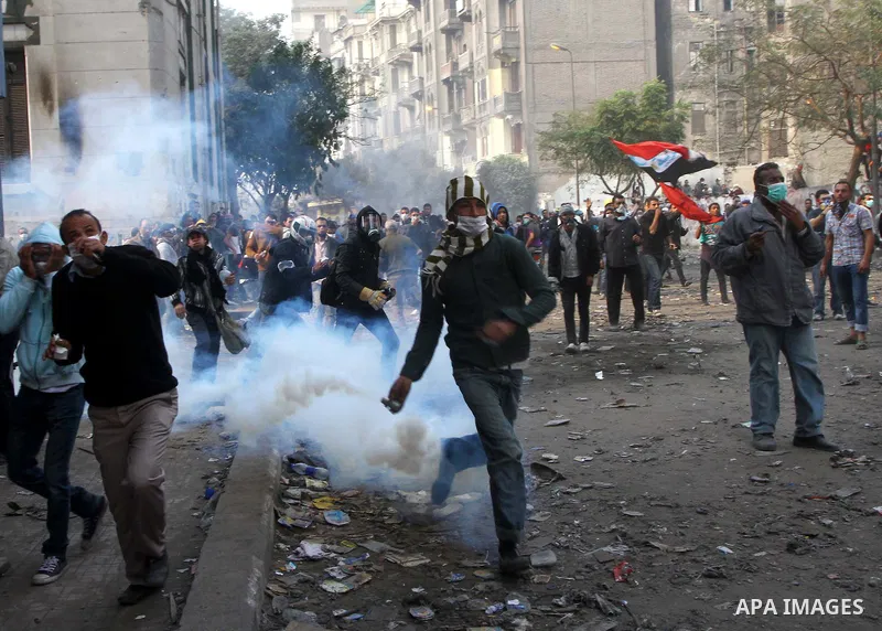 Egyptian protestors clash with riot police, not pictured, near Tahrir square in Cairo, Egypt, Wednesday, Nov. 23, 2011. Egyptian police are clashing with anti-government protesters for a fifth day in Cairo. Tens of thous...