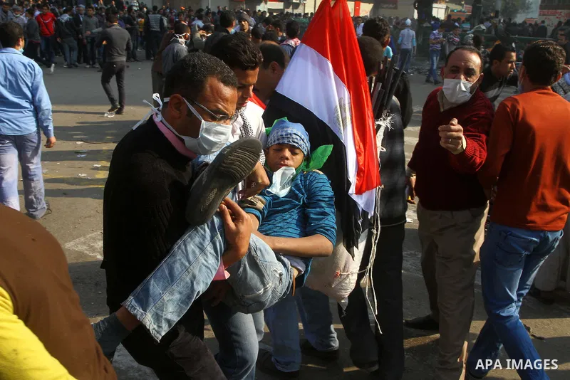 Protesters help another protester injured during clashes with riot police near Tahrir square in Cairo, Egypt, Wednesday, Nov. 23, 2011. Egyptian police are clashing with anti-government protesters for a fifth day in Cair...