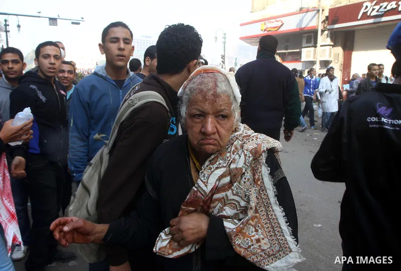 Protesters help another protester injured during clashes with riot police near Tahrir square in Cairo, Egypt, Wednesday, Nov. 23, 2011. Egyptian police are clashing with anti-government protesters for a fifth day in Cair...