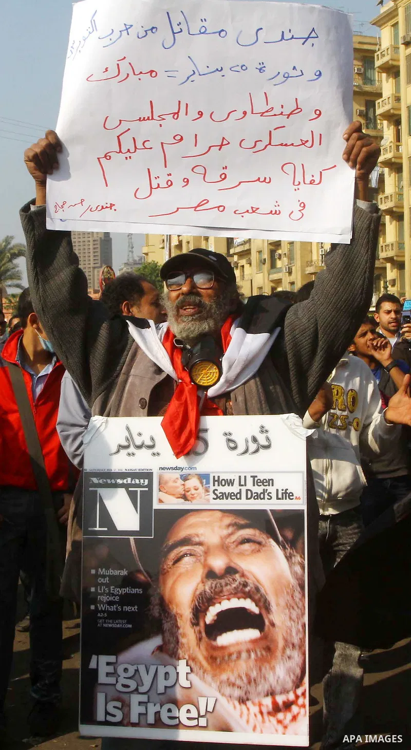 Protesters gather on Tahrir square as clashes against the anti-riot police are underway nearby in the street leading to the ministry of interior in Cairo, Egypt, Wednesday, Nov. 23, 2011. Tens of thousands of protesters...