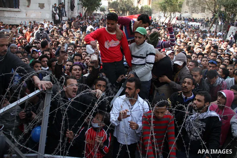 Egyptian protesters gather near barbed wire and concrete barricades around the Interior Ministry, near Cairo's Tahrir Square, November 24, 2011. A truce between Egyptian riot police and protesters succeeded on Thursday i...