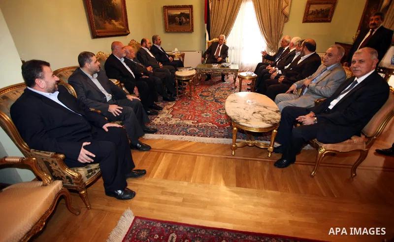 Palestinian president Mahmud Abbas meets with Hamas chief Khaled Meshaal and other top Fatah and Hamas officials in Cairo on November 24, 2011. Abbas and Meshaal hailed a new Palestinian "partnership" after talks to impl...