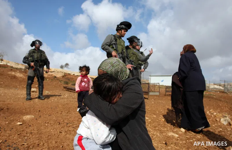 Palestinians from the Bedouin Abu Mansor family stand as Israeli forces destroy his family house in an area of the east Jerusalem neighborhood of Beit Hanina which falls in the West Bank side of Israel's separation barri...