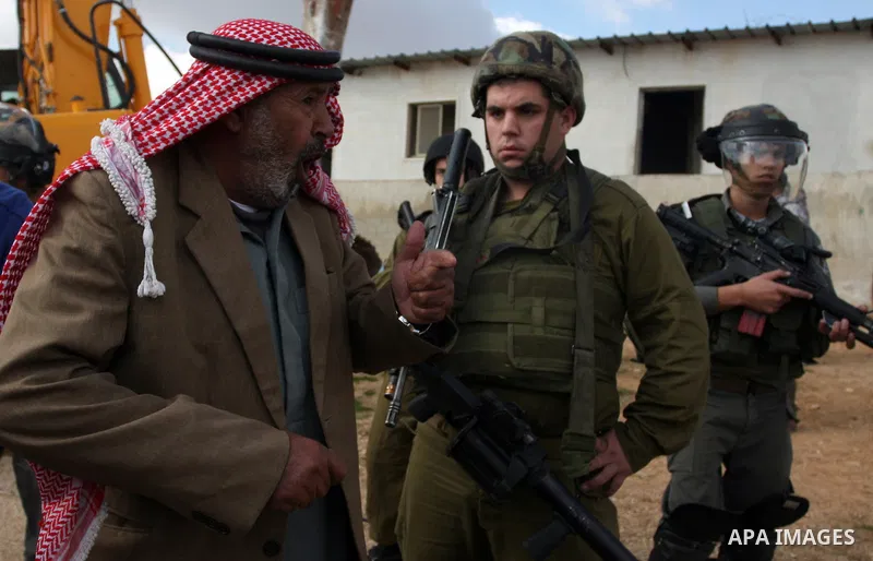 A Palestinian man from the Bedouin Abu Mansor family stands as Israeli forces destroy his family house in an area of the east Jerusalem neighborhood of Beit Hanina which falls in the West Bank side of Israel's separation...