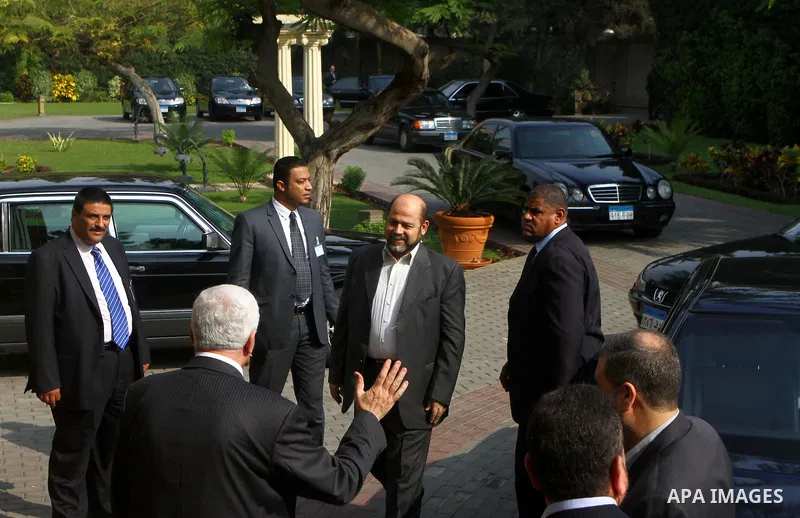 Senior Hamas leader Mousa Abu Marzouk meets with top Fatah official Azzam al-Ahmed in Cairo on November 24, 2011. Abbas and Meshaal hailed a new Palestinian "partnership" after talks to implement a landmark reconciliatio...