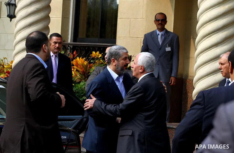 Hamas chief Khaled Meshaal meets with top Fatah official Azzam al-Ahmed in Cairo on November 24, 2011. Abbas and Meshaal hailed a new Palestinian "partnership" after talks to implement a landmark reconciliation deal. Pho...
