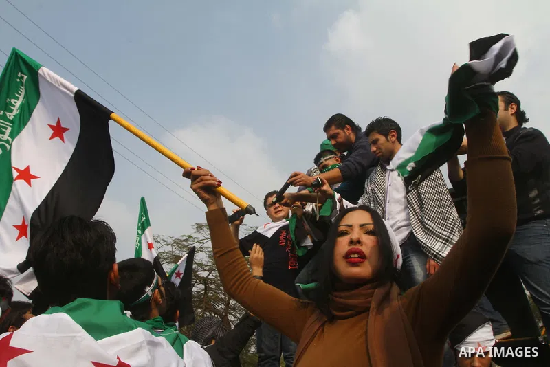 Pro-reform supporters protest outside the Arab League headquarters in the Egyptian capital Cairo, where a ministerial meeting on Syria was held on November 24, 2011. Arab foreign ministers have invited Syria to sign an a...