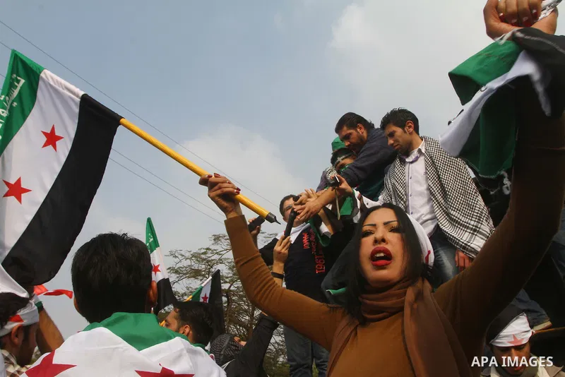 Pro-reform supporters protest outside the Arab League headquarters in the Egyptian capital Cairo, where a ministerial meeting on Syria was held on November 24, 2011. Arab foreign ministers have invited Syria to sign an a...