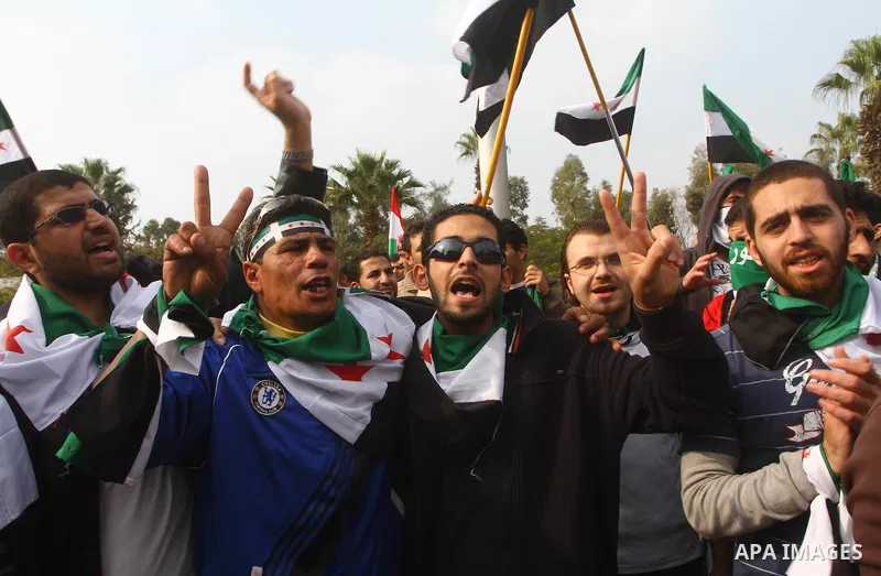 Pro-reform supporters protest outside the Arab League headquarters in the Egyptian capital Cairo, where a ministerial meeting on Syria was held on November 24, 2011. Arab foreign ministers have invited Syria to sign an a...