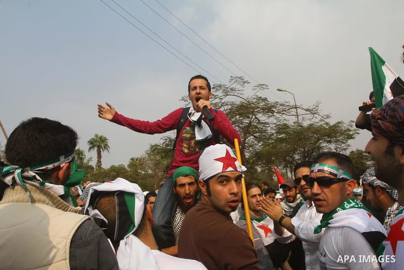 Pro-reform supporters protest outside the Arab League headquarters in the Egyptian capital Cairo, where a ministerial meeting on Syria was held on November 24, 2011. Arab foreign ministers have invited Syria to sign an a...