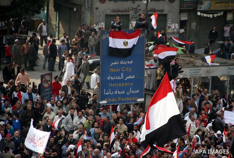 Supporters of the Egyptian Armed Forces shout slogans and wave Egyptian national flags on a road near the defence ministry, headquarters of the Supreme Council of the Armed Forces, at Abbasiya square in Cairo November 25...