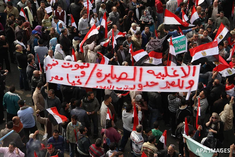 Supporters of the Egyptian Armed Forces shout slogans and wave Egyptian national flags on a road near the defence ministry, headquarters of the Supreme Council of the Armed Forces, at Abbasiya square in Cairo November 25...