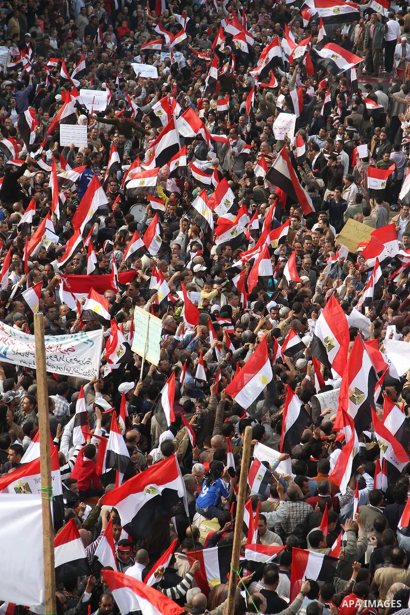 Supporters of the Egyptian Armed Forces shout slogans and wave Egyptian national flags on a road near the defence ministry, headquarters of the Supreme Council of the Armed Forces, at Abbasiya square in Cairo November 25...